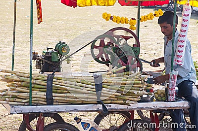 Man preparing cane sugar drink Editorial Stock Photo