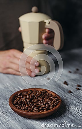 Man is preparing coffee in a beige moka pot Stock Photo