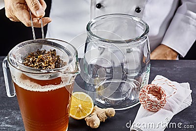 Man preparing kombucha tea in jar Stock Photo