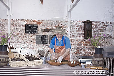 Man Preparing Speciality Sausages In Shop Stock Photo