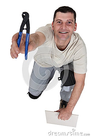 Man preparing to cut tile Stock Photo