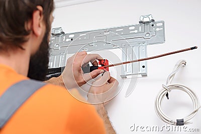 Man preparing to install new air conditioner. Modern air conditioner during the installation process Stock Photo