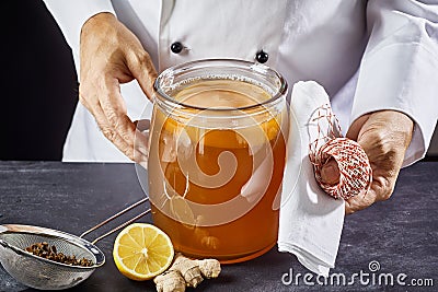 Man preparing to seal a jar of fermenting kombucha Stock Photo