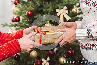 Man presenting christmas gift to girlfriend Stock Photo