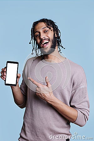 Man presenting mobile phone with white screen for advertisement Stock Photo