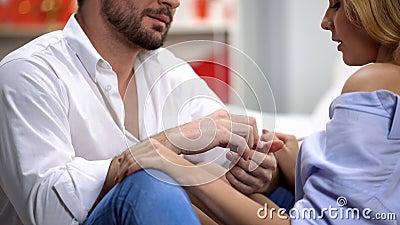 Man presenting woman precious golden engagement ring on st Valentines day Stock Photo