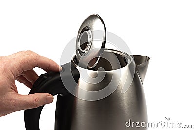 The man pressed the button to open the teapot lid. Stock Photo
