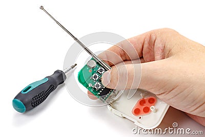 Man presses button on the disassembled security system remote co Stock Photo