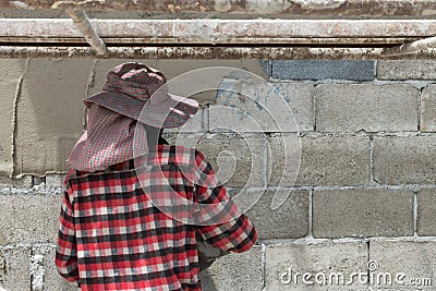 Man pressing an cement tile into a glue on a wall. Stock Photo