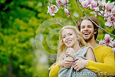 Man and pretty girl or cute woman enjoying pink magnolia Stock Photo