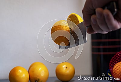 A man professionally cuts a orange Stock Photo