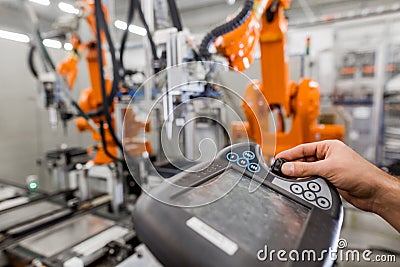 Technician man programming robot in automotive industrial, professional programmer, industry concept Stock Photo