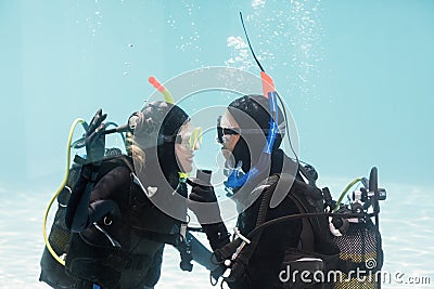 Man proposing marriage in scuba gear Stock Photo