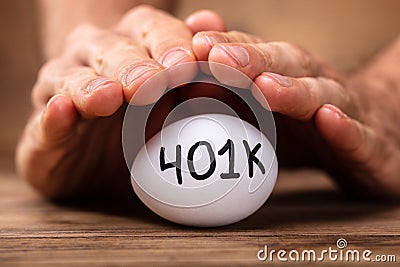 Man Protecting 401k White Egg Stock Photo