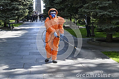 Man in protective gear sprays disinfectant to prevent spread of coronavirus disease COVID 19. Kyiv, Ukraine May 2020 Editorial Stock Photo
