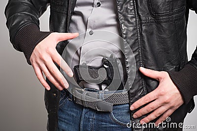 Man pulling out a gun ready Stock Photo