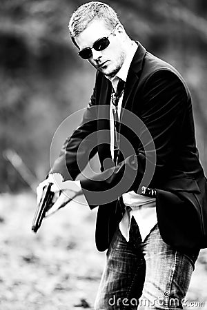 Man pulls a gun in car Stock Photo