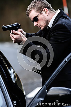 Man pulls a gun in car Stock Photo