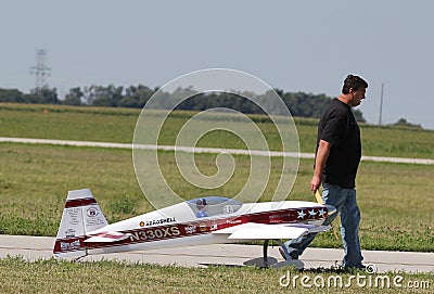 Man pulls Model Airplane Editorial Stock Photo