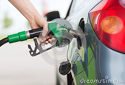 Man pumping gasoline fuel in car at gas station Stock Photo