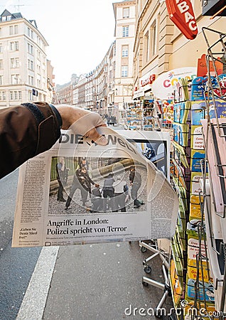 Man purchases Die Welt newspaper from press kiosk after London a Editorial Stock Photo