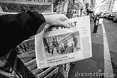 Man purchases Die Zeit newspaper from press kiosk after London a Editorial Stock Photo