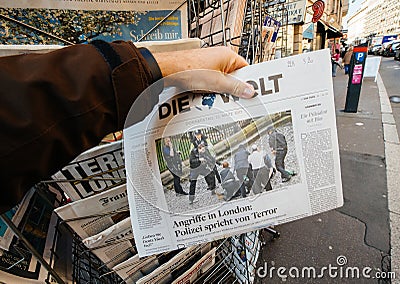 Man purchases Die Zeit newspaper from press kiosk after London a Editorial Stock Photo