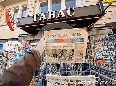 Man purchases a Financial times newspaper from press kiosk after Editorial Stock Photo