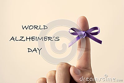 Purple ribbon and text world alzheimers day Stock Photo