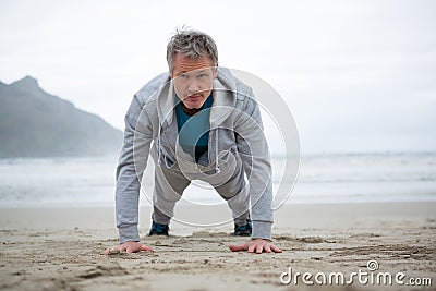 Man push-up on beach Stock Photo