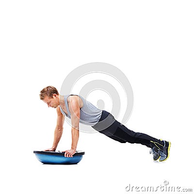 Man, push up for exercise and balance, bosu ball for core training and muscle in workout on white background. Fitness Stock Photo