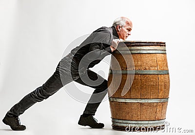 Man pushing a barrel very resolute Stock Photo