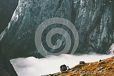 Man pushing boulder in mountains Sisyphean labor concept Stock Photo