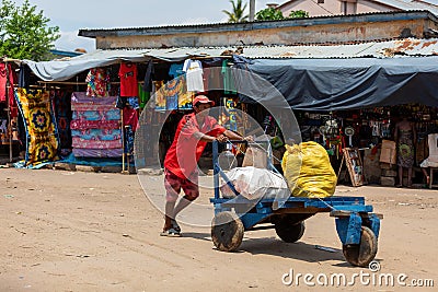 Man pushing cart with bags on street of Miandrivazo in Madagascar Editorial Stock Photo