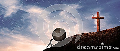 Man Pushing hardly A Big rock Up Hill in front of Jesus Christ cross. in panoramic landscape. hard worker, true believer in god Stock Photo