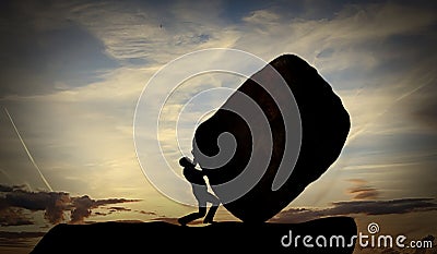 Man Pushing a large Rock At Sunset. Hard work and Heavy task Concept. The person rolls The Stone on mountain Stock Photo
