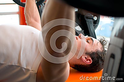 Man pushing up weights Stock Photo