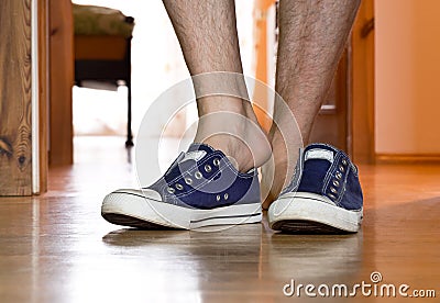 Man is puting on sneakers Stock Photo