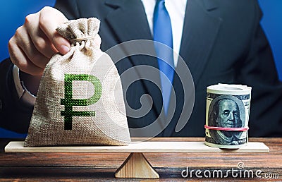 Man puts a russian ruble money bag on scales opposite to dollar bundle. Monetary policy. Central Bank Regulator. Market Stock Photo