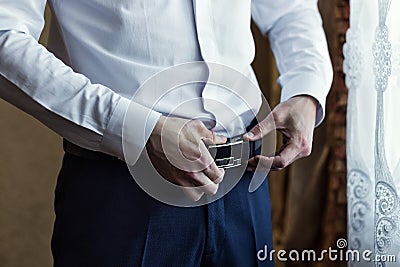 Man putting on a belt, Businessman, Politician, man`s style, mal Stock Photo