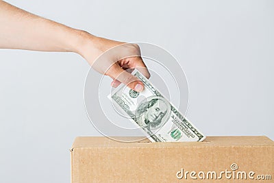 Man putting dollar money into donation box Stock Photo