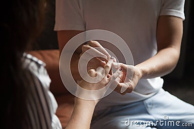 Man putting ring on womans finger, engagement wedding concept, c Stock Photo