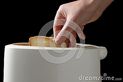 Man putting white bead slices in toaster Stock Photo