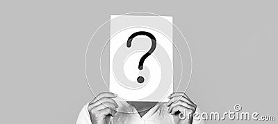 Man a question. Doubtful man holding Question Mark. Question mark, symbol. Getting answers. Portrait of man, peeking Stock Photo