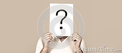 Man a question. Doubtful man holding Question Mark. Question mark, symbol. Pensive male. Getting answers. Portrait of Stock Photo