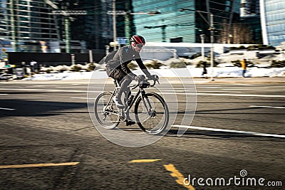 Man racing bicycle on the urban highway on high speed. Bicycle rider in the city in motion blur Editorial Stock Photo