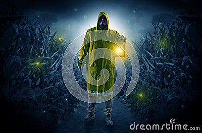 Man coming out from a thicket with lantern Stock Photo