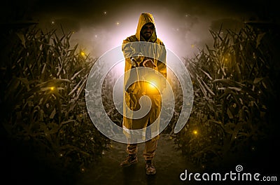 Man coming out from a thicket with lantern Stock Photo