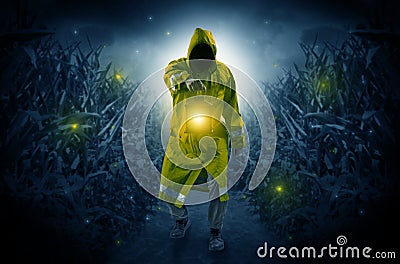 Man coming out from a thicket with lantern Stock Photo