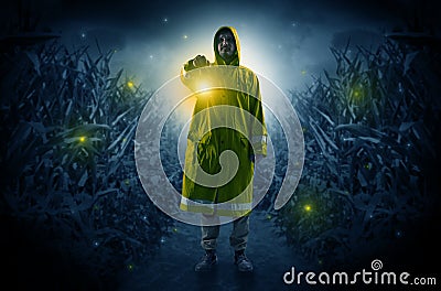 Man coming out from a thicket with lantern Stock Photo